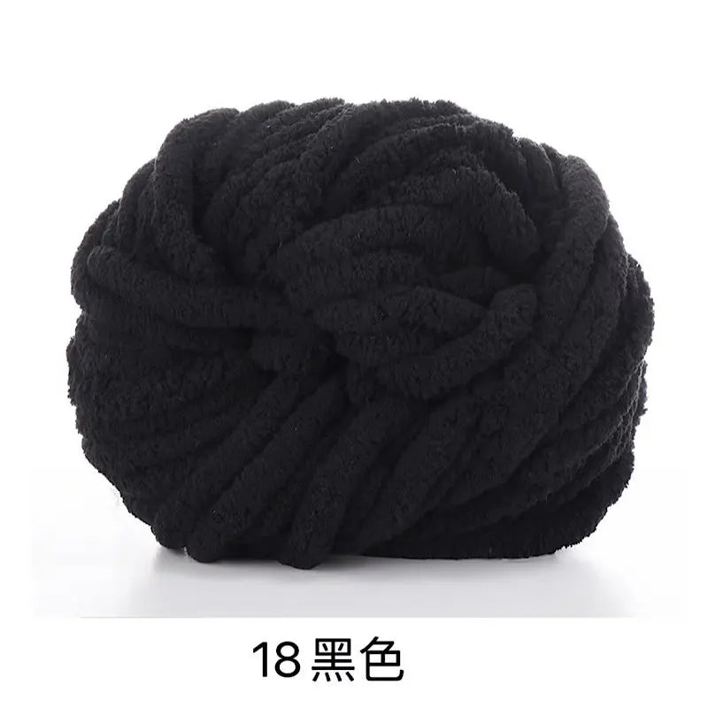 A ball of black chunky acrylic yarn used for knitting and crochet