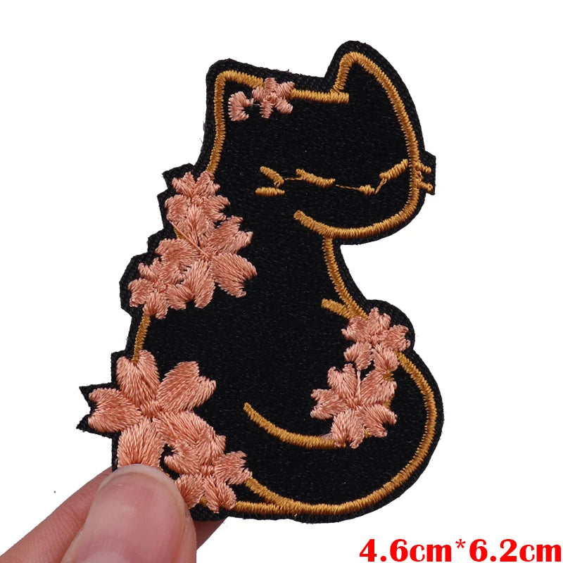 Black cat embroidered iron-on patch with pink floral accents