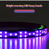A close-up of an RGB LED lamp bead light bar illuminating a surface with vibrant purple light.