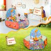 A colorful foldable kids ball pit play tent is set up outdoors on the grass, featuring a large orange-colored entrance and st