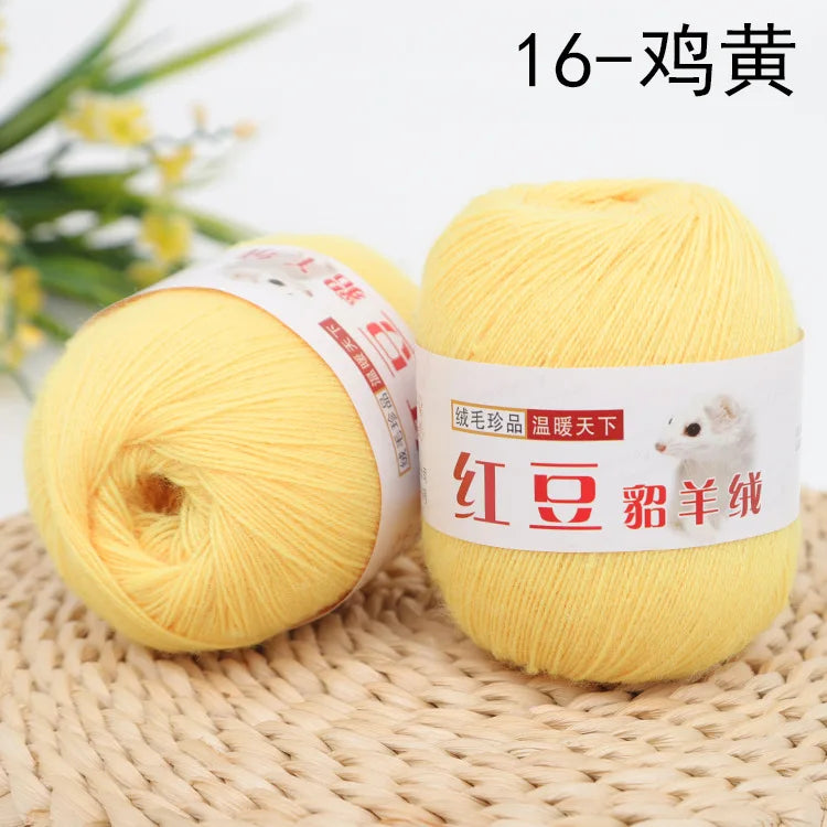 A ball of bright yellow fine yarn labeled as 16-wool, ready for knitting or crochet.
