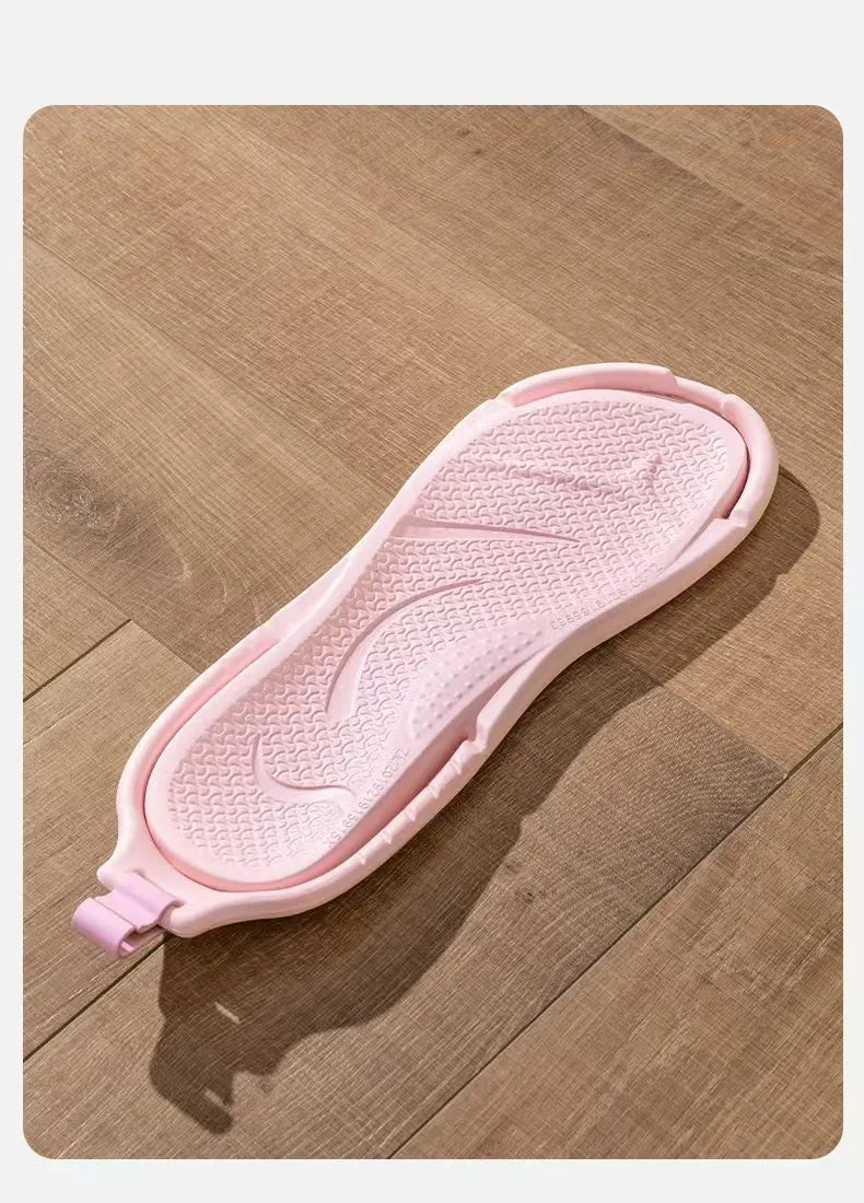 A pink foldable EVA travel slipper with a textured sole is shown on a wooden surface.