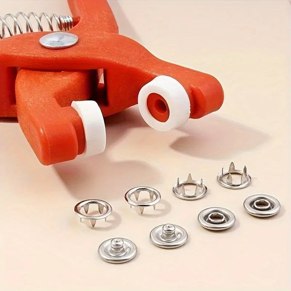 Orange snap button kit with manual press pliers and various silver metal fasteners for DIY projects
