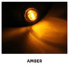 Close-up of an amber LED side marker light illuminating a bright, warm glow.