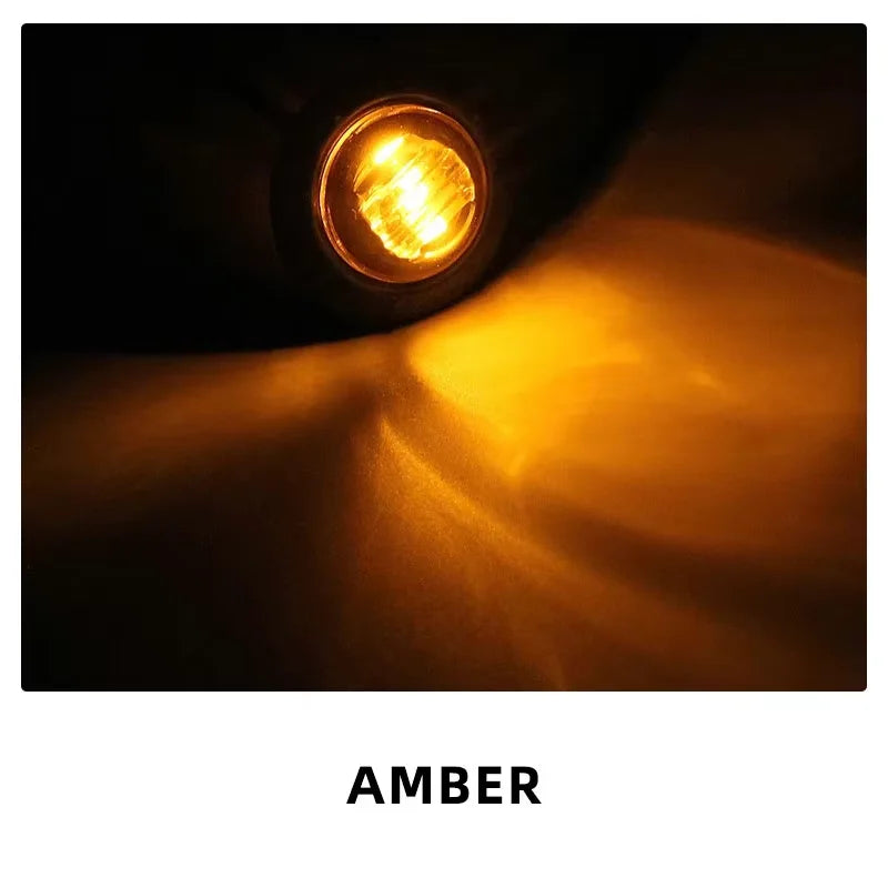 Close-up of an amber LED side marker light illuminating a bright, warm glow.