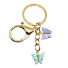 Gold-toned butterfly keychain charm with a purple and light blue butterfly detail