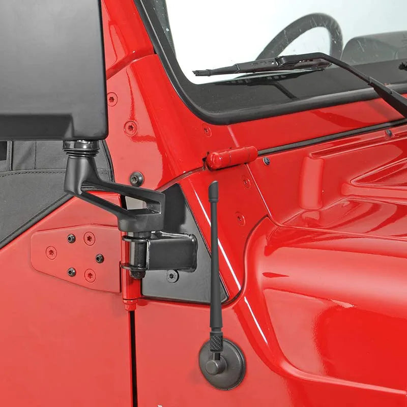 A close-up view of a red vehicle interior showing a mounted radio antenna.
