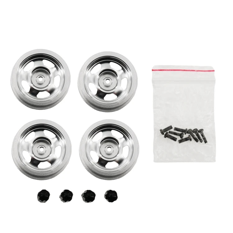 A set of four metal RC car upgrade wheels with rims and a bag containing small screws.