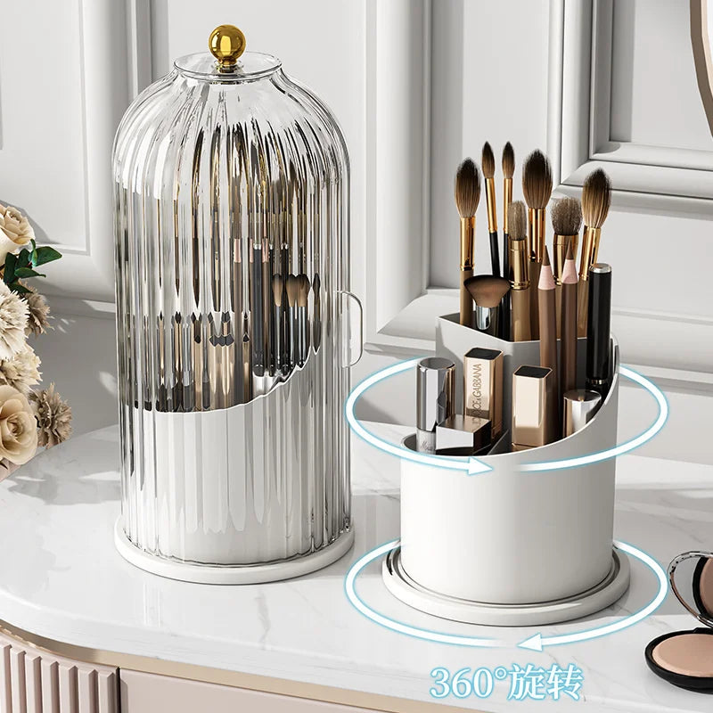 A clear glass organizer with a lid holds various makeup brushes and tools for organization.