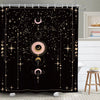 A black shower curtain featuring a bold design of celestial bodies, including moons, stars, and dots.