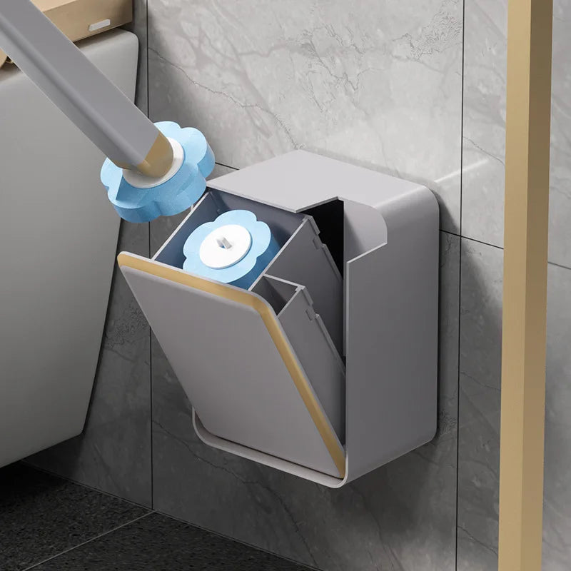 A hand is using a long brush to clean the interior of a wall-mounted disposable toilet brush set.