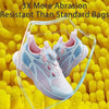 A pair of light blue and pink athletic shoes inside a clear protective bag against a yellow textured background.