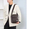 A model wearing a cream blazer and black shirt holds a brown multi-pocket crossbody chest bag.
