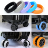 A set of four silicone suitcase wheel protectors in various colors, including black, gray, purple, and orange.