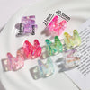 A collection of colorful acrylic alphabet beads in various shades and sizes displayed on a white plate.