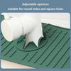A white adjustable aperture silicone drain mat is shown fitting into a green textured kitchen or bathroom drain.