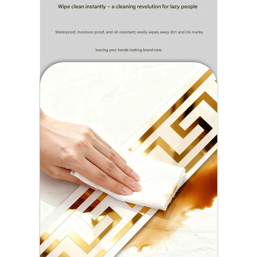 A hand wipes a gold-edged white PVC trim with a white cloth on a marble surface.