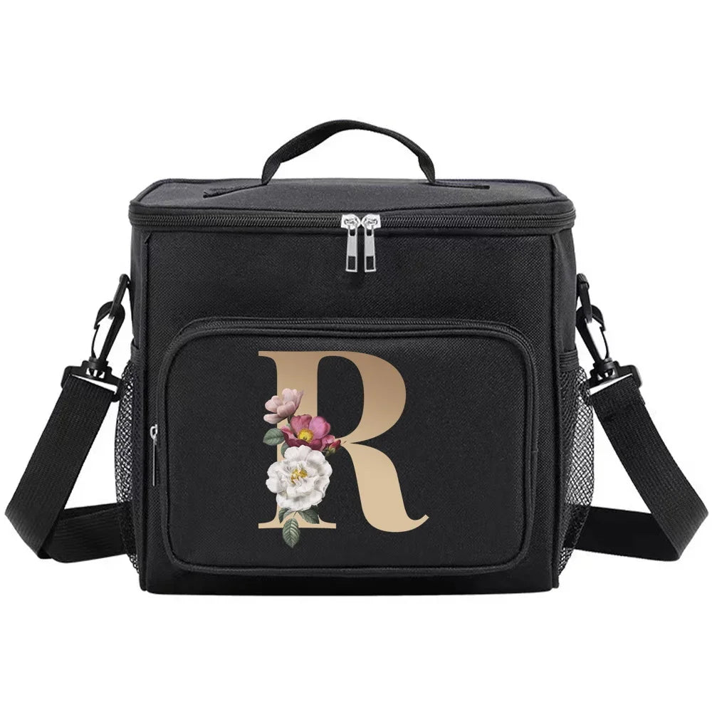 Black insulated canvas lunch bag with a gold initial R and adjustable strap