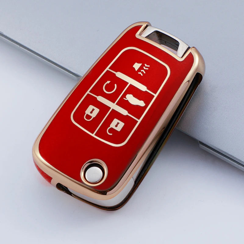 A red and gold protective TPU key fob cover for a vehicle, showing various key cutouts.