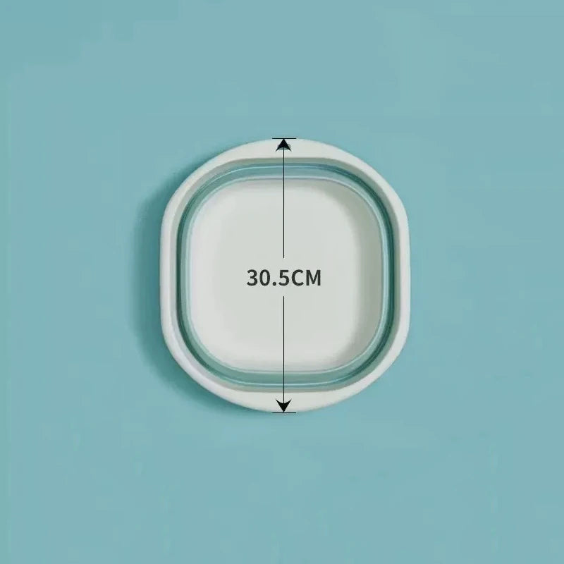 A white foldable plastic wash basin shown with dimension markings on a light blue background.