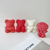 Three 3D rose bear silicone molds in pink and white colors displayed on a white surface.