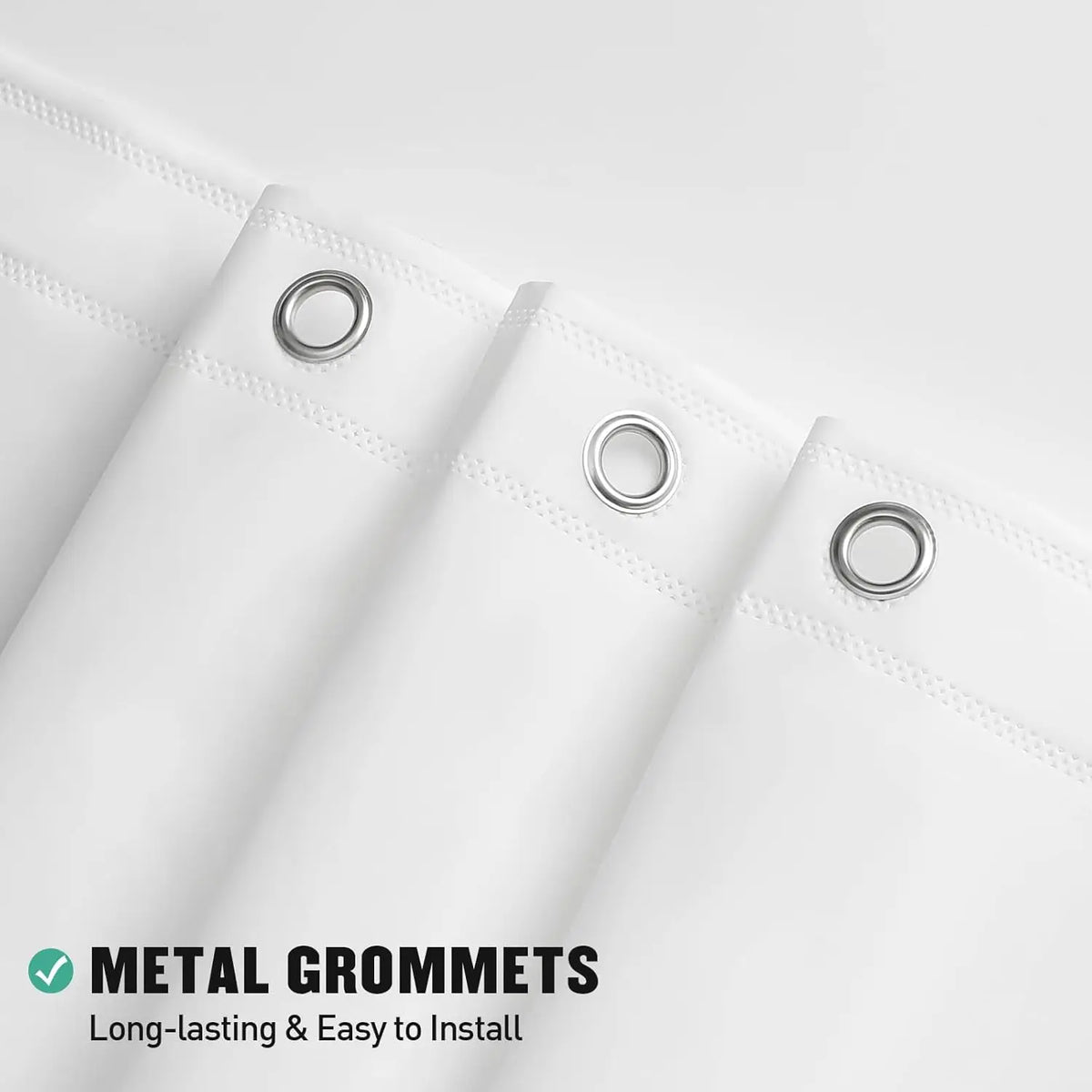 Close-up of a white shower curtain liner featuring metal grommets for easy installation.