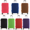 A set of four brightly colored suitcase covers in pink, blue, brown, and purple.