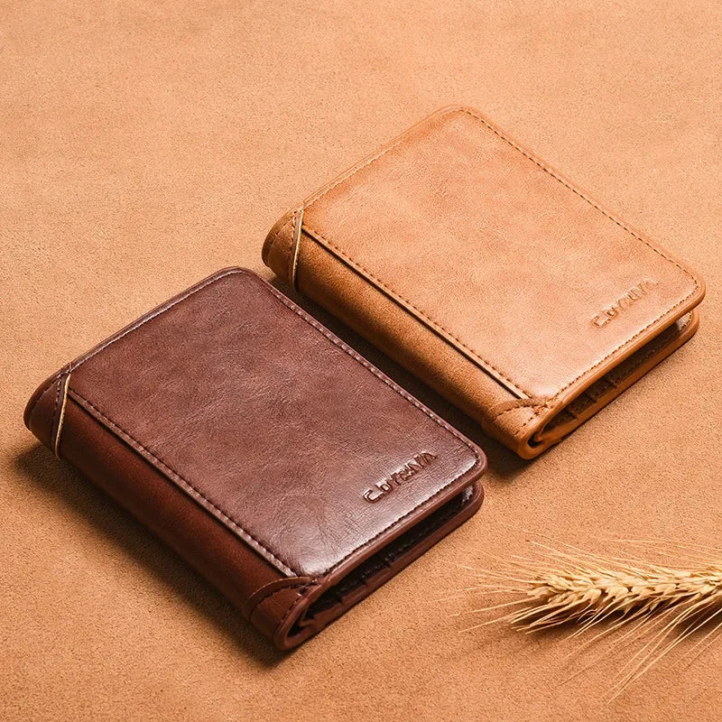 A brown slim PU leather card holder wallet for men resting on a tan background next to wheat stalks.