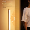 A close-up of a wireless motion sensor LED cabinet light illuminating a wall, demonstrating infrared sensing range.