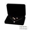 Elegant black velvet jewelry storage and gift box containing a silver necklace with pearl pendants