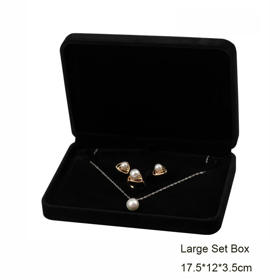 Elegant black velvet jewelry storage and gift box containing a silver necklace with pearl pendants