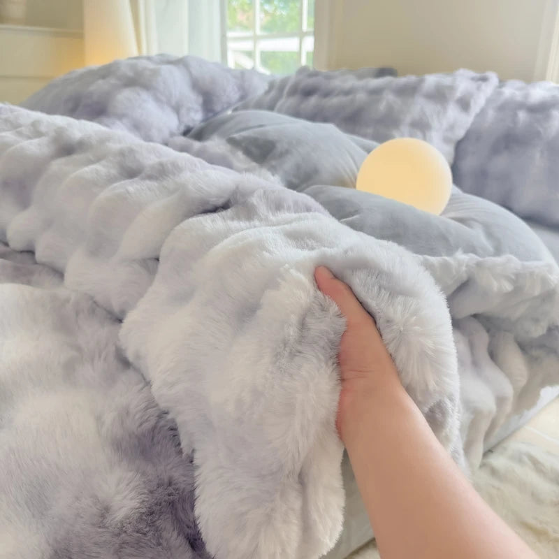 A hand is touching a fluffy gray and white fleece duvet cover with a rabbit design on a bed.