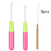 A set of three plastic latch hook needles with green and pink handles and gold tips for crafting