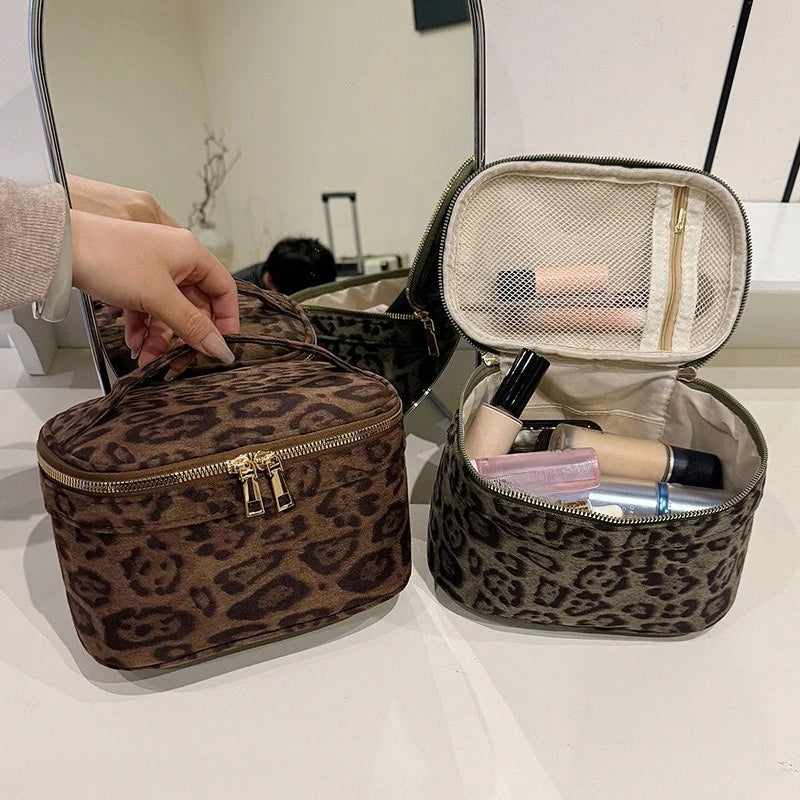 A brown leopard print cosmetic bag with a zippered top and an open interior showing various makeup products.