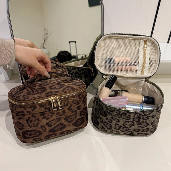 A brown leopard print cosmetic bag is shown open, revealing multiple compartments and makeup products.