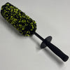 A black wheel barrel brush with a yellow-green bristled head and an ergonomic handle.