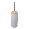 A bamboo bathroom organizer set featuring a cylindrical dispenser with a metal rod.