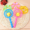 A set of pink and yellow squeaky rubber duck bath toys resting on a woven mat.