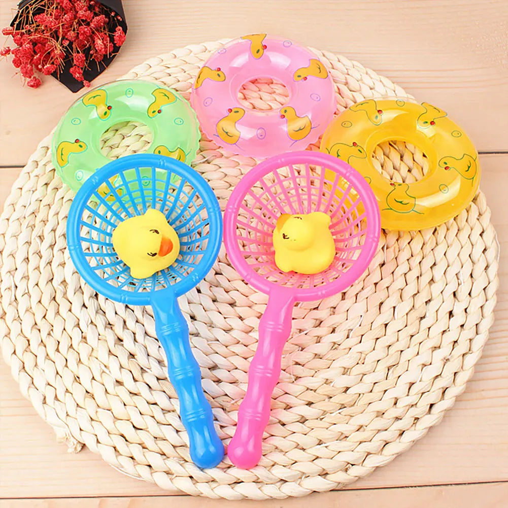 A set of pink and yellow squeaky rubber duck bath toys resting on a woven mat.
