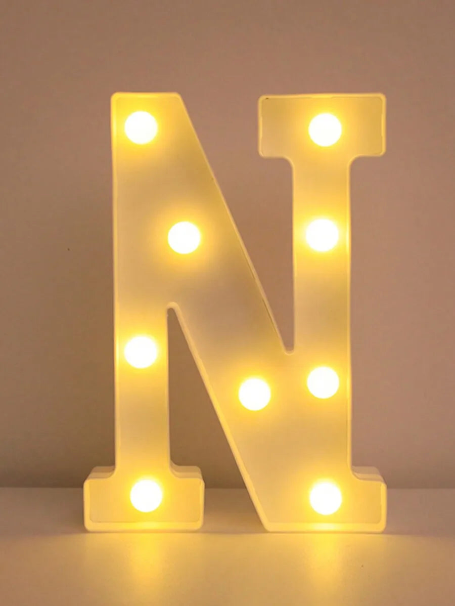 A glowing neon sign shaped like the letter N made of LED lights on a white surface.