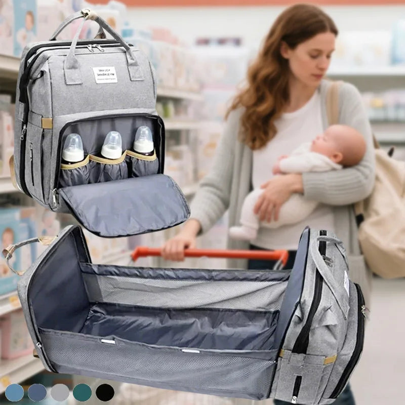 A gray backpack diaper bag with a removable changing mat is shown being held by a woman in a store setting.