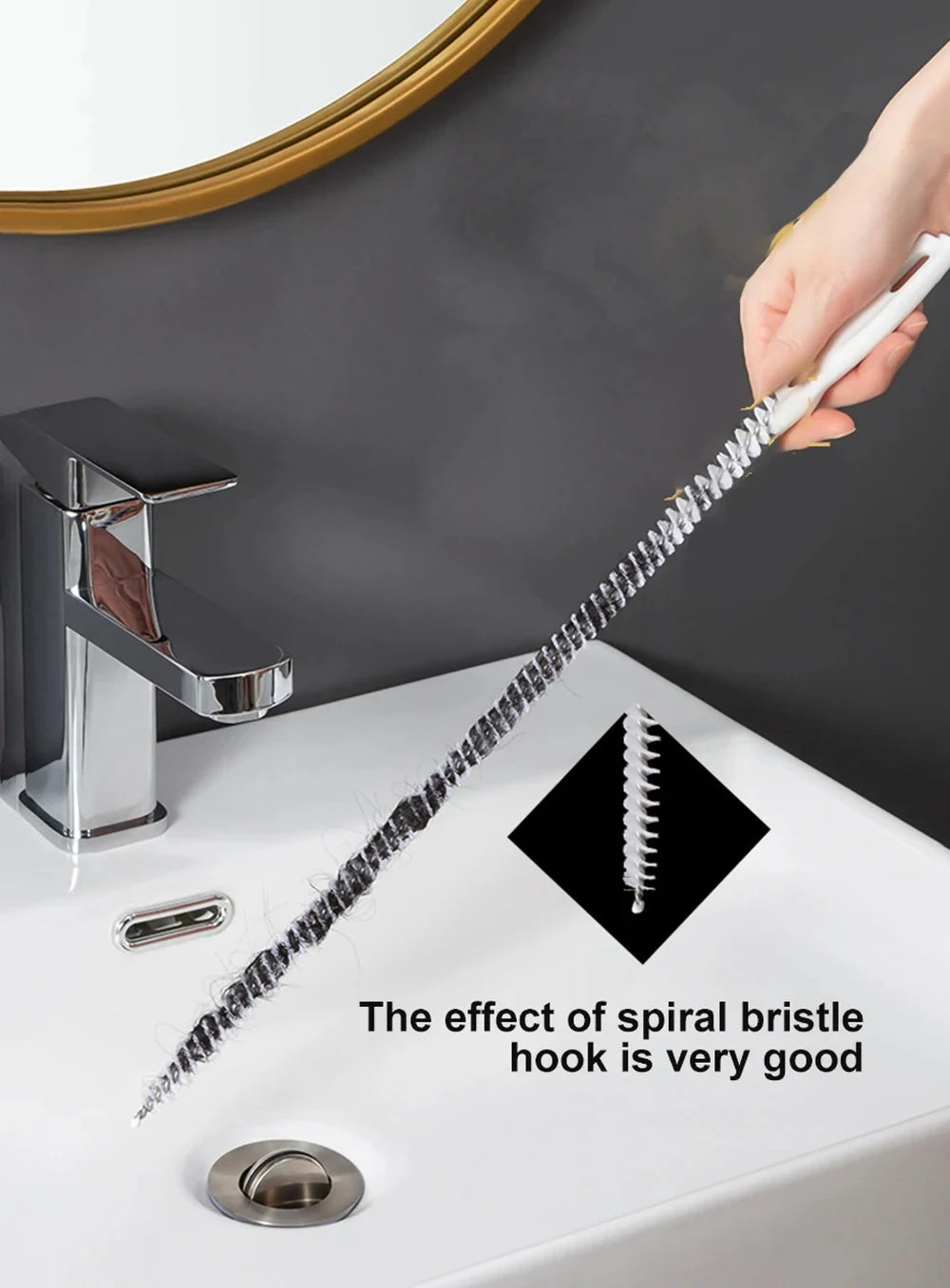 A hand is using a flexible drain cleaning brush with a spiral bristle to clean a sink drain.