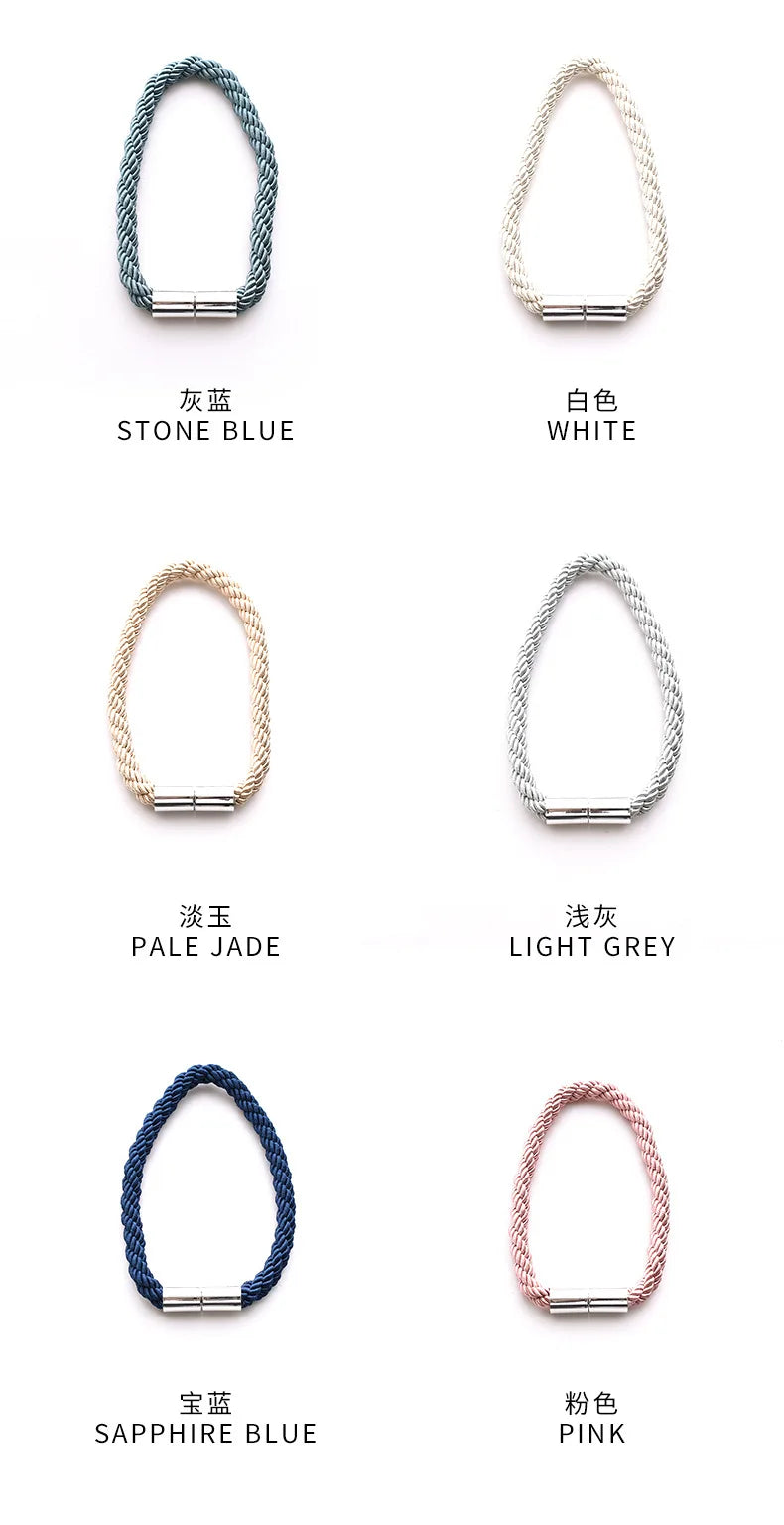A set of two magnetic curtain tiebacks featuring rope texture and silver-toned hardware in blue, white, jade, grey, and pink 