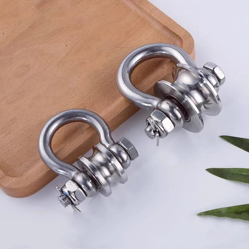 A heavy-duty 304 stainless steel pulley with a silent bearing resting on a wooden surface.