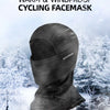 A dark gray cycling facemask is shown against a snowy outdoor background.
