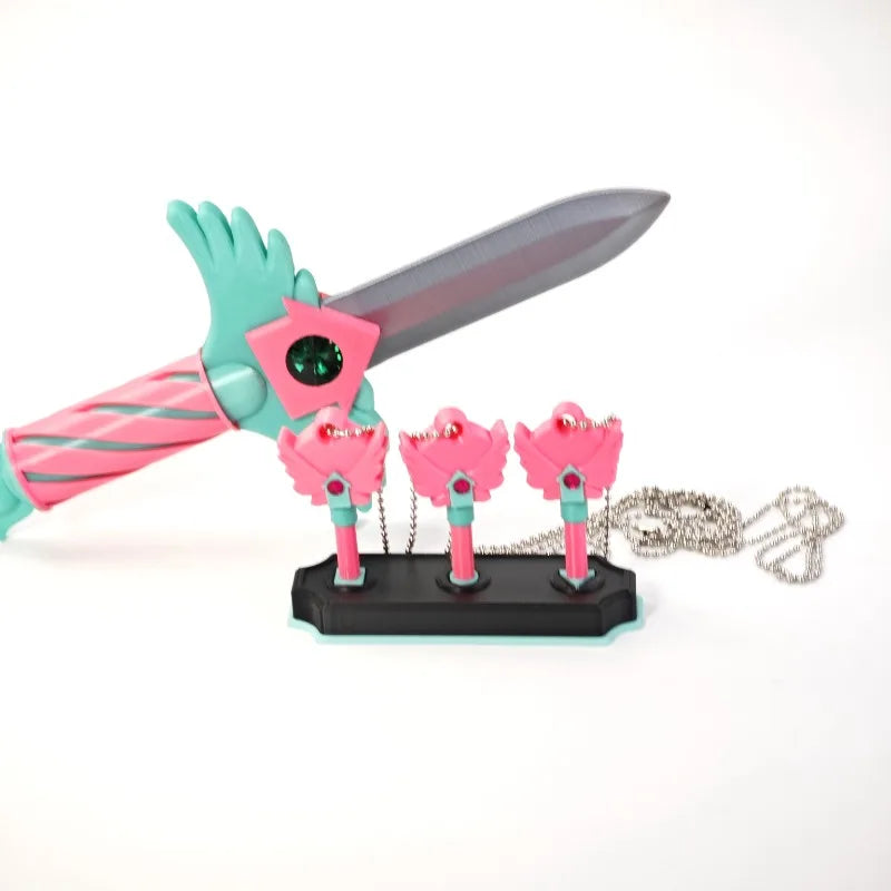 A set of four pink and teal dagger key necklaces displayed on a black stand.