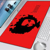 A red gaming mouse pad featuring a black silhouette of a skull and crossbones design.