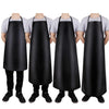 A black PU leather waterproof apron shown on a person, suitable for kitchen and cleaning tasks.