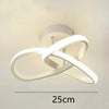 Modern white LED ceiling light shaped like a clover or infinity symbol mounted on a ceiling.