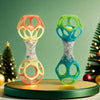 A pair of colorful baby rattle toys with soft teether beads in orange and green on a wooden stand.